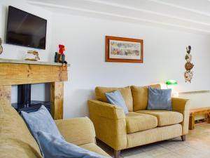 a living room with a couch and a fireplace at The Imaginary Barn in Hartland