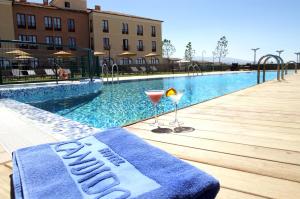 
a blue pool sitting on top of a wooden deck at Hotel Cándido in Segovia
