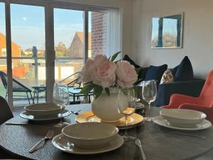 a table with a vase of flowers on top of it at Coastal 2 Bathroom Apartment, Free Parking in Moreton