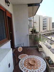 a patio with a table and chairs on a balcony at Suite Laterani 3 bedrooms with parking in Rome