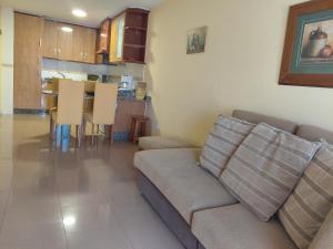 a living room with a couch and a table at Apartamentos As Caldelas in O Grove