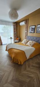 a bedroom with a large bed and a large window at Chambre Gaëlle et Brian in Cardet