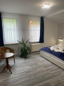 Un dormitorio con una cama, una mesa y una silla. en Ferienwohnung, en Rheinsberg