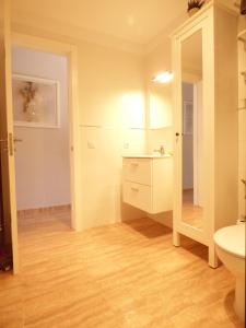 a bathroom with a sink and a toilet and a mirror at Departamento Jose in Puerto del Carmen