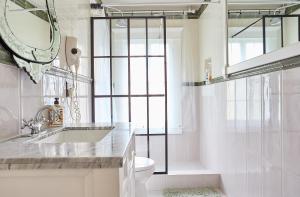 a bathroom with a sink and a toilet and a mirror at Hollywood Home in Los Angeles