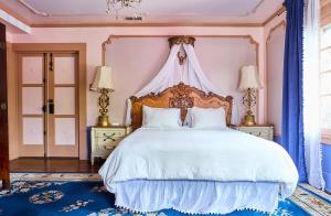 a bedroom with a large white bed with a canopy at Hollywood Home in Los Angeles