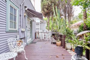 a wooden deck with chairs and tables on a house at Hollywood Home in Los Angeles +33 photos