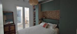 a bedroom with a bed and a book shelf at maison Saint Jean de Luz 6 personnes piscine et jacuzzi in Saint-Jean-de-Luz