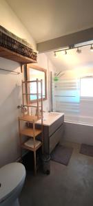 a bathroom with a sink and a toilet and a window at maison Saint Jean de Luz 6 personnes piscine et jacuzzi in Saint-Jean-de-Luz