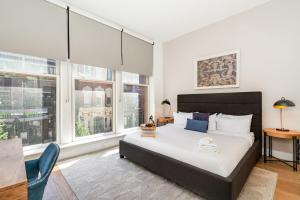 a bedroom with a large bed and windows at The Saddlery-Southern Set-2 Units-Walk to Broadway in Nashville
