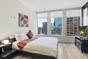 a bedroom with a large bed and large windows at 2 Bed 2 Bath Stylish Luxury Premium High-Rise Apartment in Los Angeles