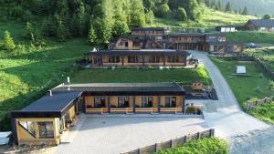 an aerial view of a large house in the mountains at Panoramic Residence in Borşa