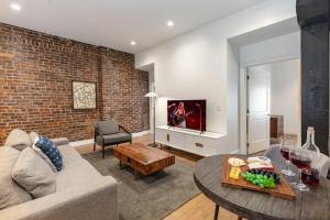 a living room with a couch and a table at The Saddlery-Tracklist-2 Units-Walk to Broadway in Nashville