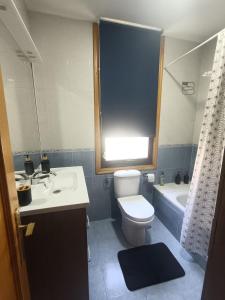 a bathroom with a toilet and a sink and a tub at Casa Allariz in Allariz