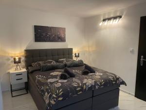 a bedroom with a large bed with a large headboard at Second home apartment - rose gold in Kustići