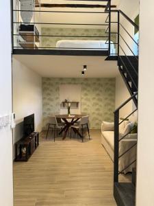 a living room with a table and a bunk bed at Riviera Collection - Rooms and Suites in Naples