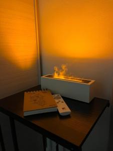 a remote control sitting on top of a table at Garden Lake Apartment in Peschiera del Garda