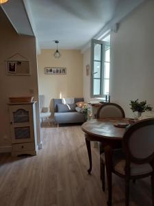 a living room with a table and a couch at Riverview in Sospel