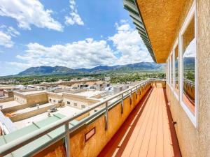 a balcony with a view of a city at Iconic Downtown Colorado Springs Penthouse with 2000 Sq Ft Rooftop Deck, 10 Person Hot Tub and Stunning Mountain Skyline Views, Two Fireplaces, and Two Lavish Primary Suites in Colorado Springs