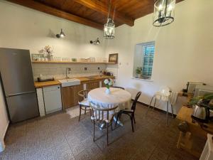 a kitchen with a table and chairs and a sink at Lelle Cottage in Balatonlelle