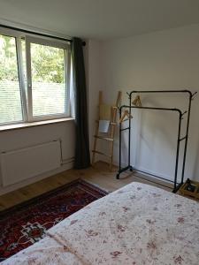 a bedroom with a bed and a window at B&B Het Heusje in Zaandam