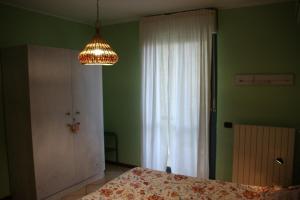 a bedroom with a bed and a chandelier at Sotto la Rocca in Angera