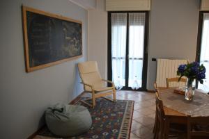 a living room with a table and chairs and a chalkboard at Sotto la Rocca in Angera +3 photos
