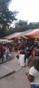 a crowd of people standing around a market with umbrellas at Lapa Casa Hostel in Rio de Janeiro