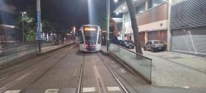 a train is coming down the tracks at night at Lapa Casa Hostel in Rio de Janeiro