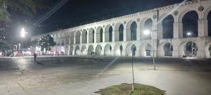 a large building with a courtyard at night at Lapa Casa Hostel in Rio de Janeiro