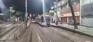 a train on tracks in a city at night at Lapa Casa Hostel in Rio de Janeiro