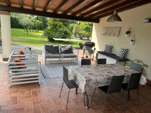 a patio with a table and chairs on a patio at Podere Venanzio in Lido di Camaiore