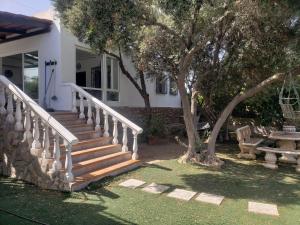 a house with stairs and a picnic table and a tree at cortijo el pedregal in Almería