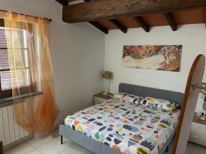 a bedroom with a bed and a painting on the wall at Podere Venanzio in Lido di Camaiore +59 photos