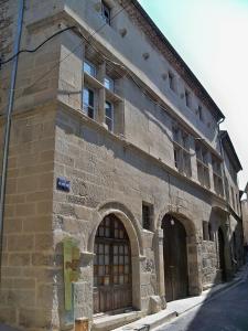 an old stone building with a large door and a window at Val d'Amour in Valréas