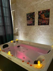 a bath tub with candles in it in a bathroom at Val d'Amour in Valréas +24 photos
