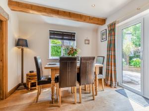 a dining room with a table and chairs at Perkins Cottage in Ashover