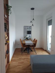 a dining room with a table and chairs at Apartman Nina Residence Banja Luka in Banja Luka