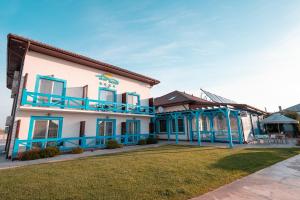 a house with blue trim and a yard at Pensiunea Blue House in Murighiol