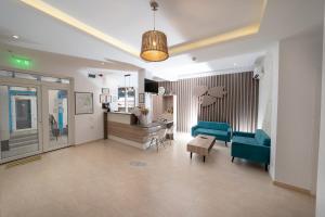 a living room with two green chairs and a table at Pensiunea Blue House in Murighiol