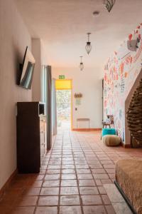 a living room with a tile floor and a hallway at Casa Trujillo in Capilla de Guadalupe