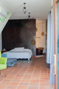 a bedroom with a bed and a tub in it at Casa Trujillo in Capilla de Guadalupe
