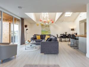 a living room with a couch and a table at Woodend Barn in Auchterarder
