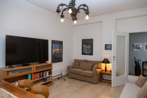a living room with a flat screen tv and a couch at Casa Angelika near Milan, Malpensa, Rho Fiera in Legnano