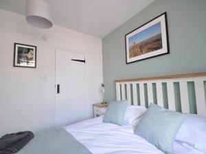 a bedroom with a bed and a picture on the wall at Cornerstones in Ambleside +15 photos