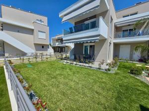 a large apartment building with a lawn in front of it at Elenidanaib in Ofrínion