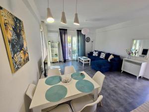 a dining room and living room with a table and chairs at Elenidanaib in Ofrínion