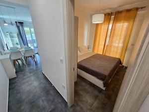 a small bedroom with a bed and a dining room at Elenidanaib in Ofrínion +6 photos