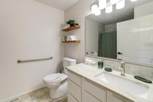 a bathroom with a toilet and a sink and a mirror at 7 Mi to Dtwn Charming Retreat with Yard in Boise in Boise +17 photos