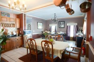 a kitchen and dining room with a table and chairs at Naomi's Inn Bed & Breakfast in Springfield